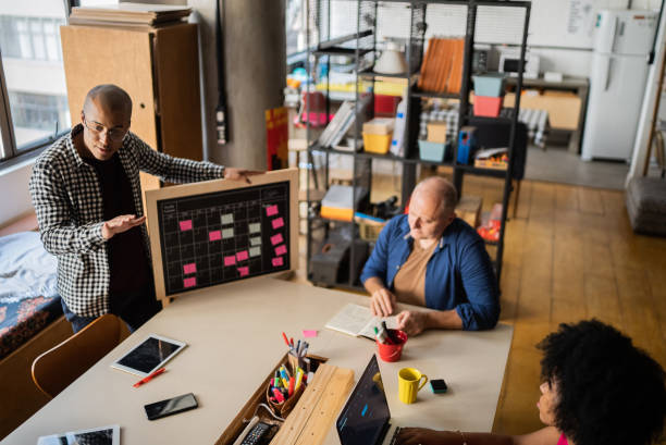 istock Young man talking in a meeting with team at work 1342255612