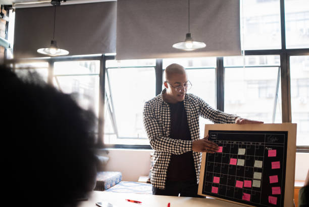 istock Young man talking in a meeting with team at work 1342255645