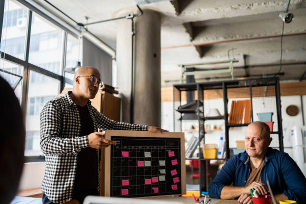 istock Young man talking in a meeting with team at work 1342255944