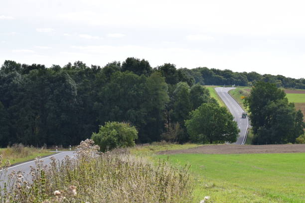 istock curvy country road through a small valley 1342256579