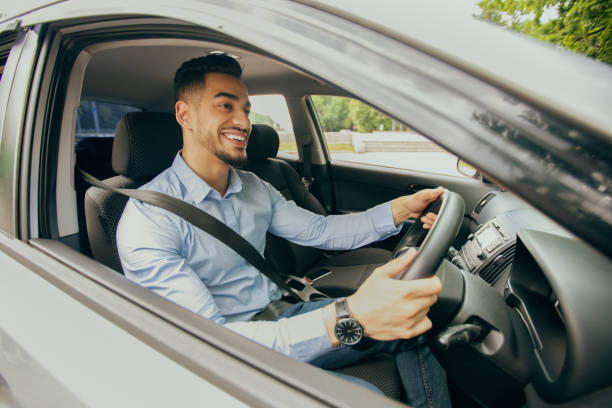 istock Positive middle-eastern guy going to office, driving car 1342256750