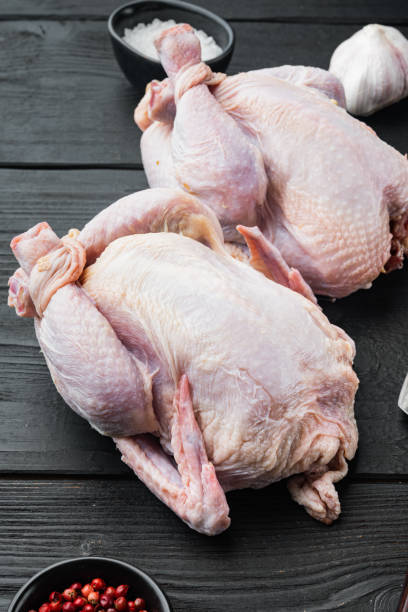 istock Fresh whole poult with herbs spices ingredients, on black wooden table 1342262377