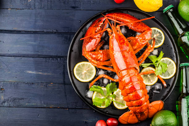 istock Seafood feastLemon and fresh Boston lobster on the ice 1342262396