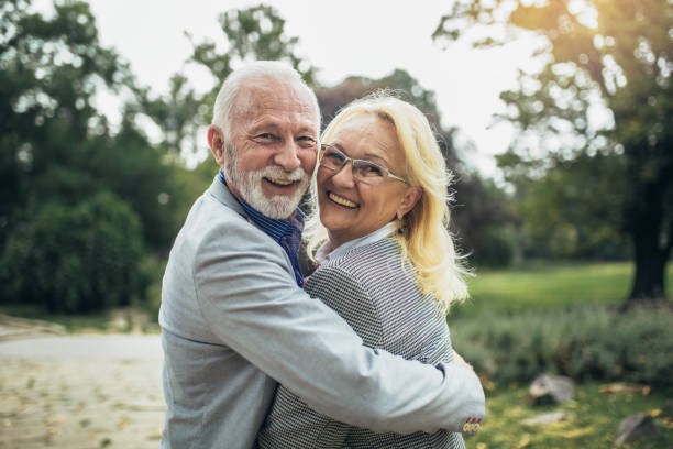 istock Happy senior couple in autumn park 1342264346