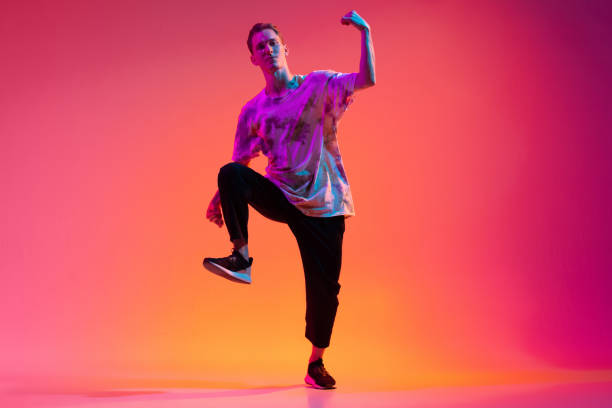 istock One energetic young man hip-hop dancer training isolated over gradient pink background in neon light 1342265632