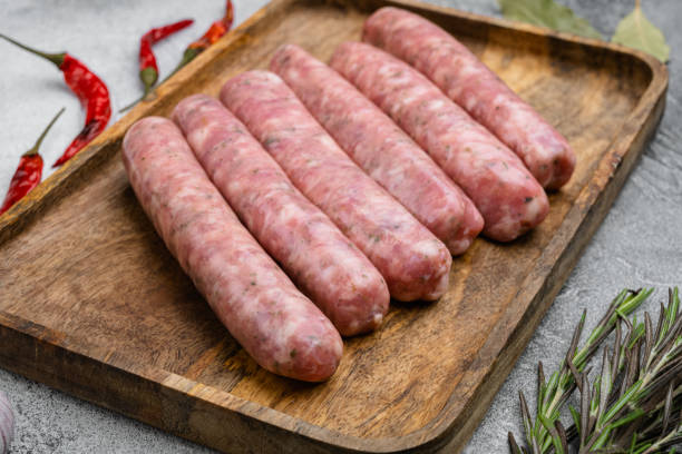 istock Raw Sausages with Herbs and Spices, on gray stone table background 1342265980