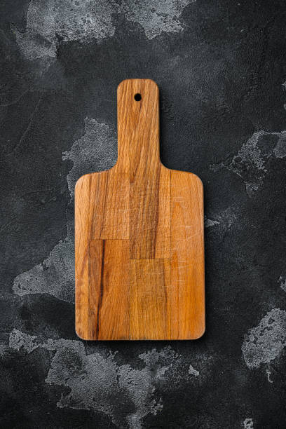 istock Scratched chopping board, on black dark stone table background, top view flat lay , with copy space for text or your product 1342267006