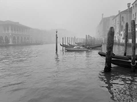 Venice, Italy, January 27, 2020 evocative black and white image of the Grand Canal on a foggy day