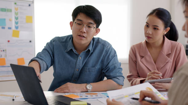 istock Small group of asia people, data analyst mba college student or smart sale team worker share plan idea on seminar training class at office desk in seo SME project, young leader creative design job. 1342269185