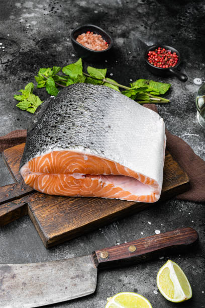 istock Salmon cut, on black dark stone table background 1342269230