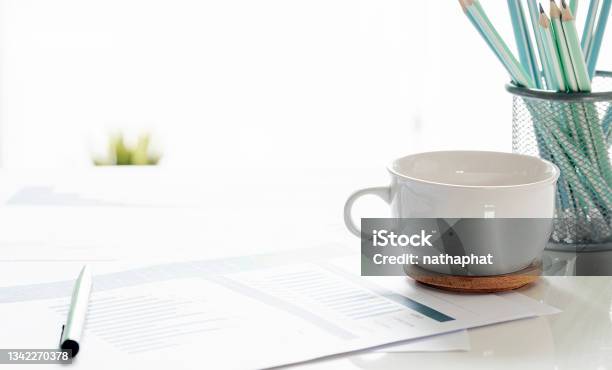 Closeup White Cup And Paperwork With Copy Space Stock Photo - Download Image Now - Cup, Pencil, Table