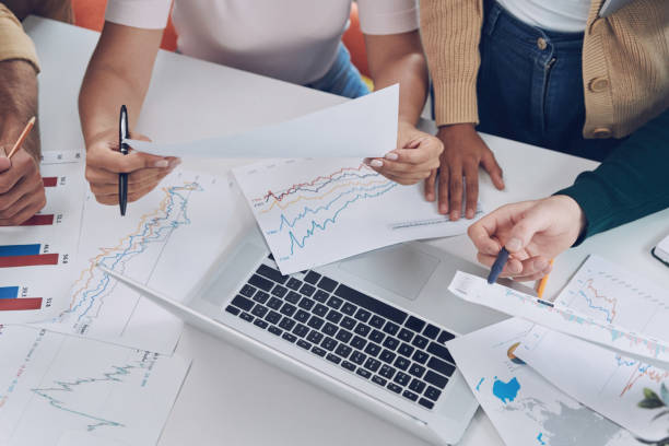 istock Close-up top view of modern people in smart casual analyzing data 1342271487
