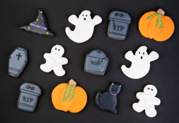 istock Halloween gingerbreads, pumpkin, cat, ghost, tombstone over black background 1342271882