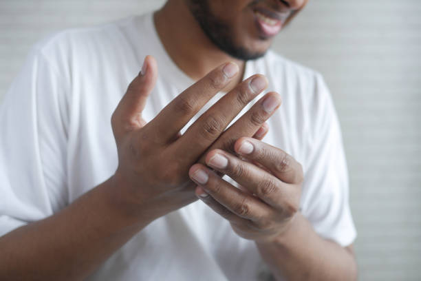 istock upset man suffering pain in hand close up 1342273459