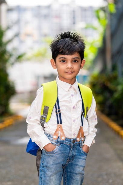 istock Little boy going to school with his school bag. 1342277340