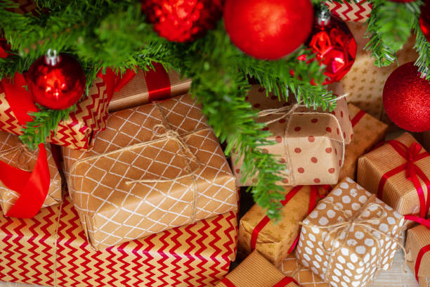 Stack of wrapped presents under Christmas tree Stack of wrapped presents under Christmas tree perfect gift stock pictures, royalty-free photos & images