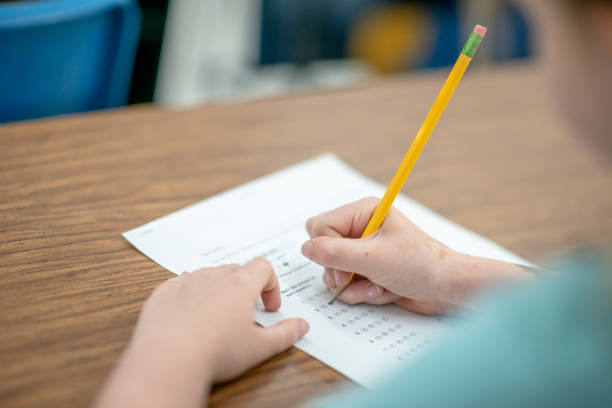 istock Over the Shoulder of a Student Writing 1342280675