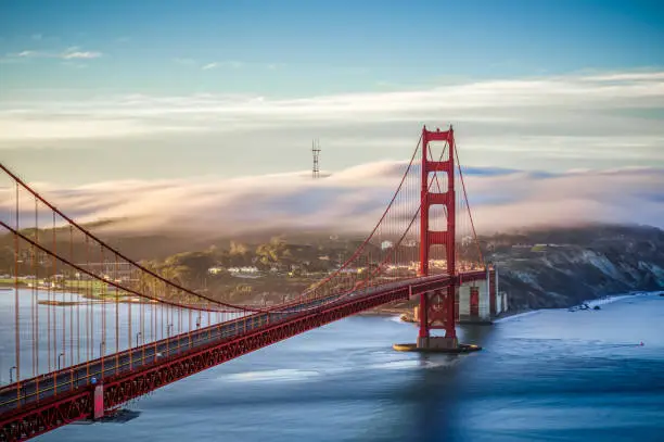 Photo of Golden Gate bridge with clouds over San Francisco, California. USA