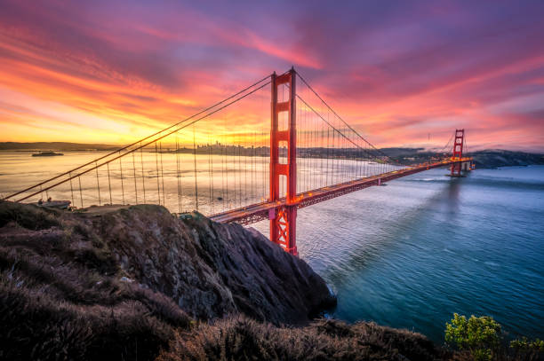 awesome sunrise in golden gate bridge, san francisco, usa coloured sunrise in golden gate bridge, san francisco, usa golden gate bridge stock pictures, royalty-free photos & images