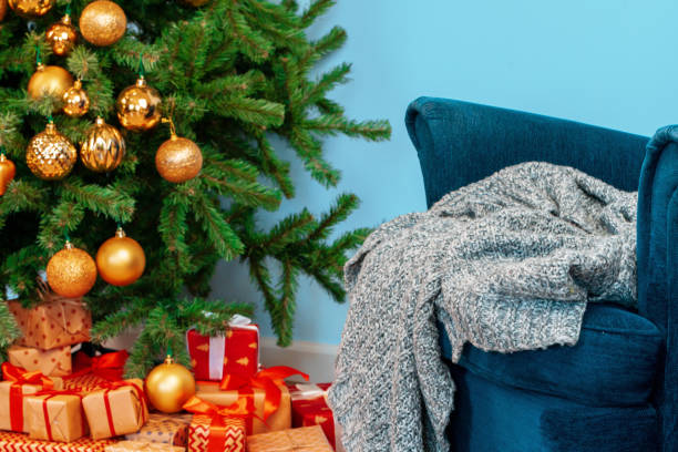istock Holiday interior. Beautiful decorated christmas tree with blue armchair 1342282056