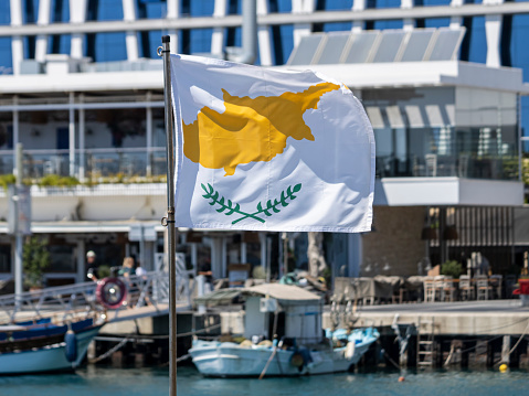 Cypriot flag waving in Limassol Old port, Cyprus
