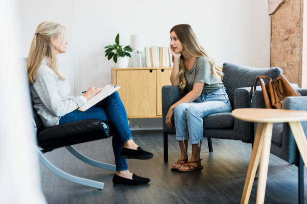 istock Young woman puts head on hand while sharing in therapy 1342284442
