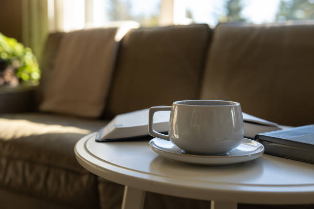 istock morning coffee and open book at couch 1342285387