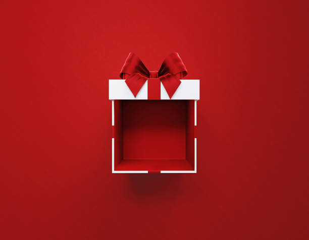 Open White Gift Box Tied With Red Ribbon Sitting Over Red  Background Open white gift box tied with red ribbon on red background. Horizontal composition with copy space. Directly above. Great use for Christmas and Valentine's Day related gift concepts. present box stock pictures, royalty-free photos & images