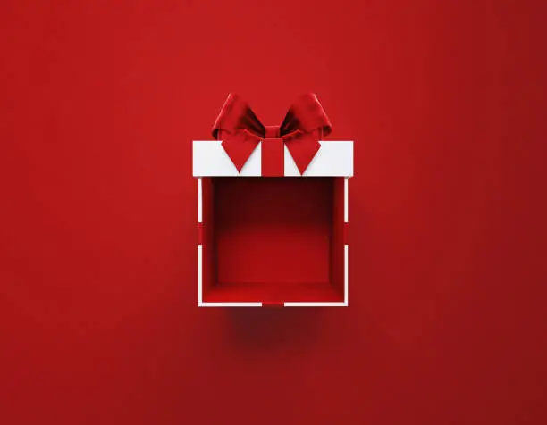 Photo of Open White Gift Box Tied With Red Ribbon Sitting Over Red  Background