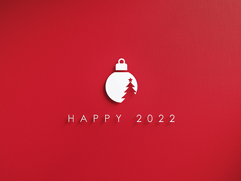 White cutout bauble and Happy 2022 message over red background. Horizontal composition with copy space. Happy new year and Christmas concept.