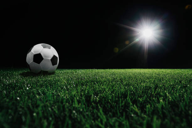 istock football field with glowing spotlight 1342291112