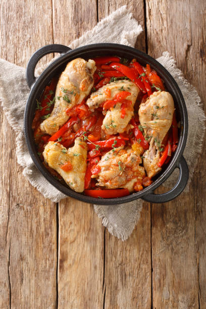 istock Basque Style Chicken with Peppers close up in the pan. Vertical top view 1342291203