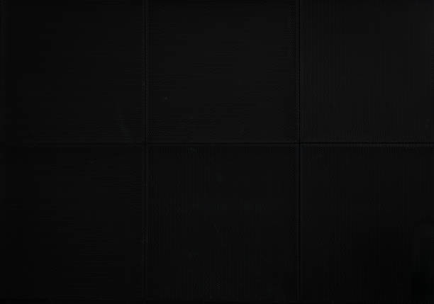 istock the black perforated steel sheet. dark black background. 1342297873