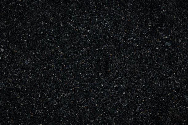 istock black pebbles laid on the floor as an image for making the dark black background. 1342297899