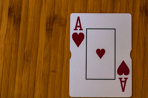 Four aces playing cards on grey background. Poker play in casino. Gambling concept