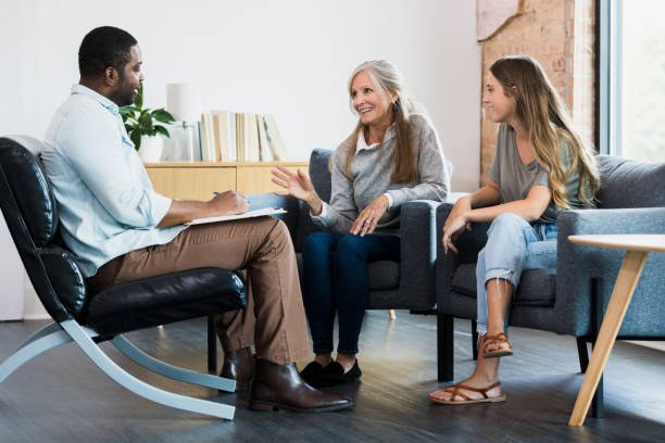 istock Mature mom gestures while talking with male counselor 1342300621
