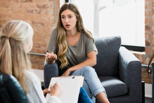 istock Young woman expresses feelings during counseling session 1342300630