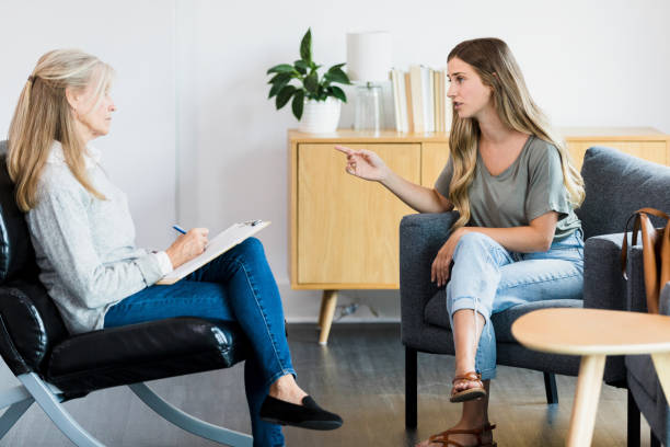 istock Young woman talks with female counselor 1342300632