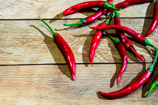 istock Red hot peppers on wooden table 1342301503