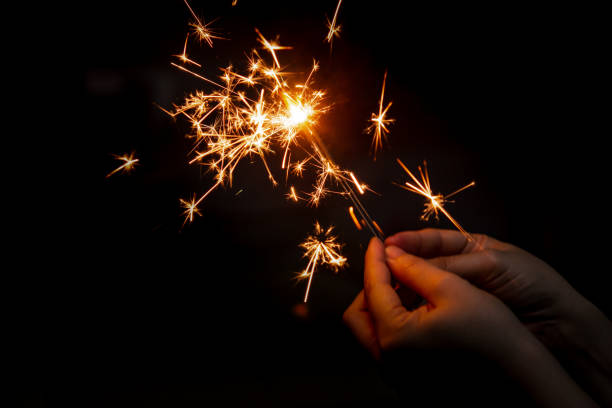 istock Female hand holding a burning sparkler, 1342307096