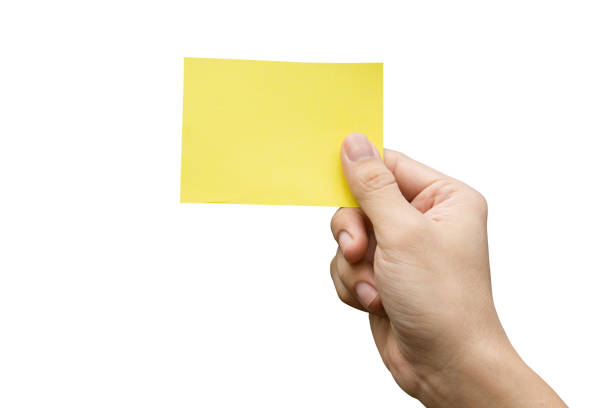 istock Hand holding yellow paper isolated on white 1342307153