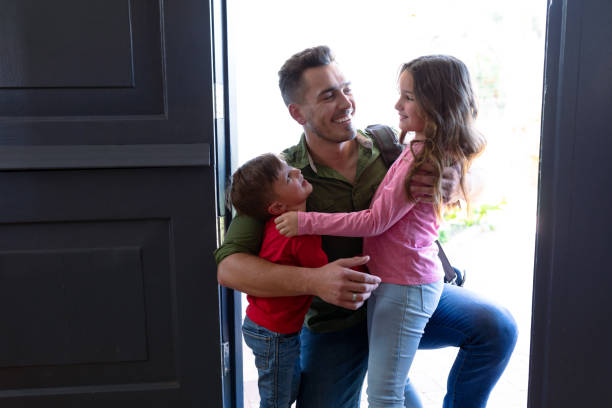 istock Happy caucasian siblings welcoming father returning home after work 1342308806