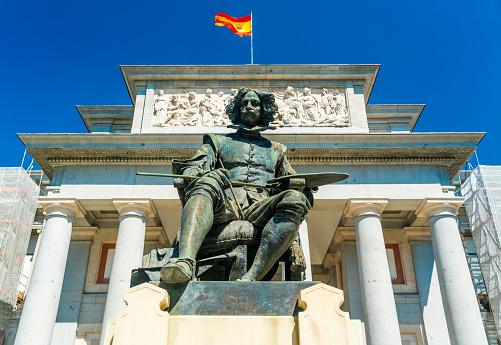 Madrid, Spain - August 18, 2021: The Statue of Velazquez was unveiled in 1899 in downtown Madrid, Spain in front of the Prado Museum.  Diego Velazquez was a Spanish artist who lived between 1599 and 1660