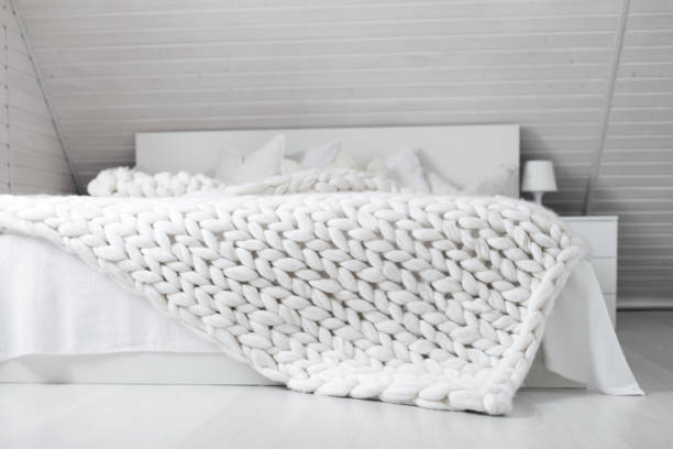 istock White nordic bedroom interior with knit plaid 1342314252