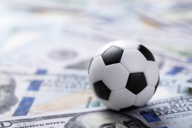 istock Soccer ball on dollar banknotes 1342315115