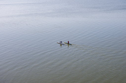 Bilgorod-Dnistrovskiy, Odesa region, Ukraine- 15 September 2021: Photo of a morning sport training session at the Dnistrovsky estuary of two sportsmen-rowers. View from the wall of the Akkerman fortress.