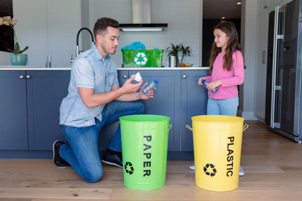 istock Happy caucasian father and daughter segregating rubbish 1342317573