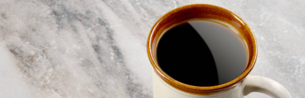 istock Cup of coffee on the marble texture background 1342317946