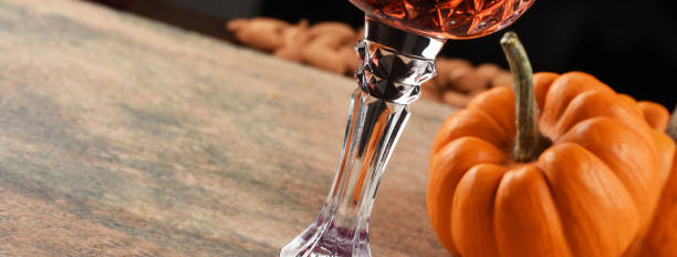 istock Wineglass with pumpkin on the table. Halloween concept 1342317961