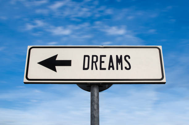 istock Dreams road sign, arrow on blue sky background. 1342319132